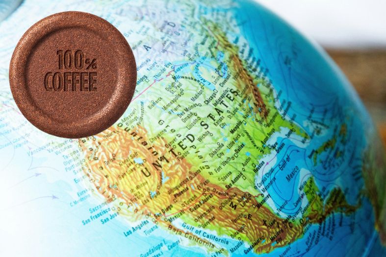 Tablì Lavazza in primo piano con mappa degli Stati Uniti sullo sfondo, simbolo del lancio sul mercato americano